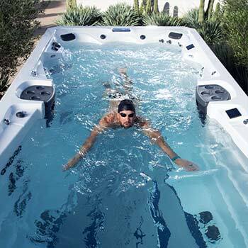 Phelps changing the settings on swim spa touchscreen.