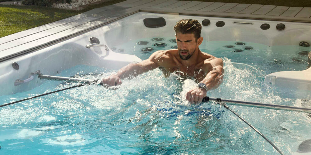 Phelps rowing with the exercise kit in a swim spa.